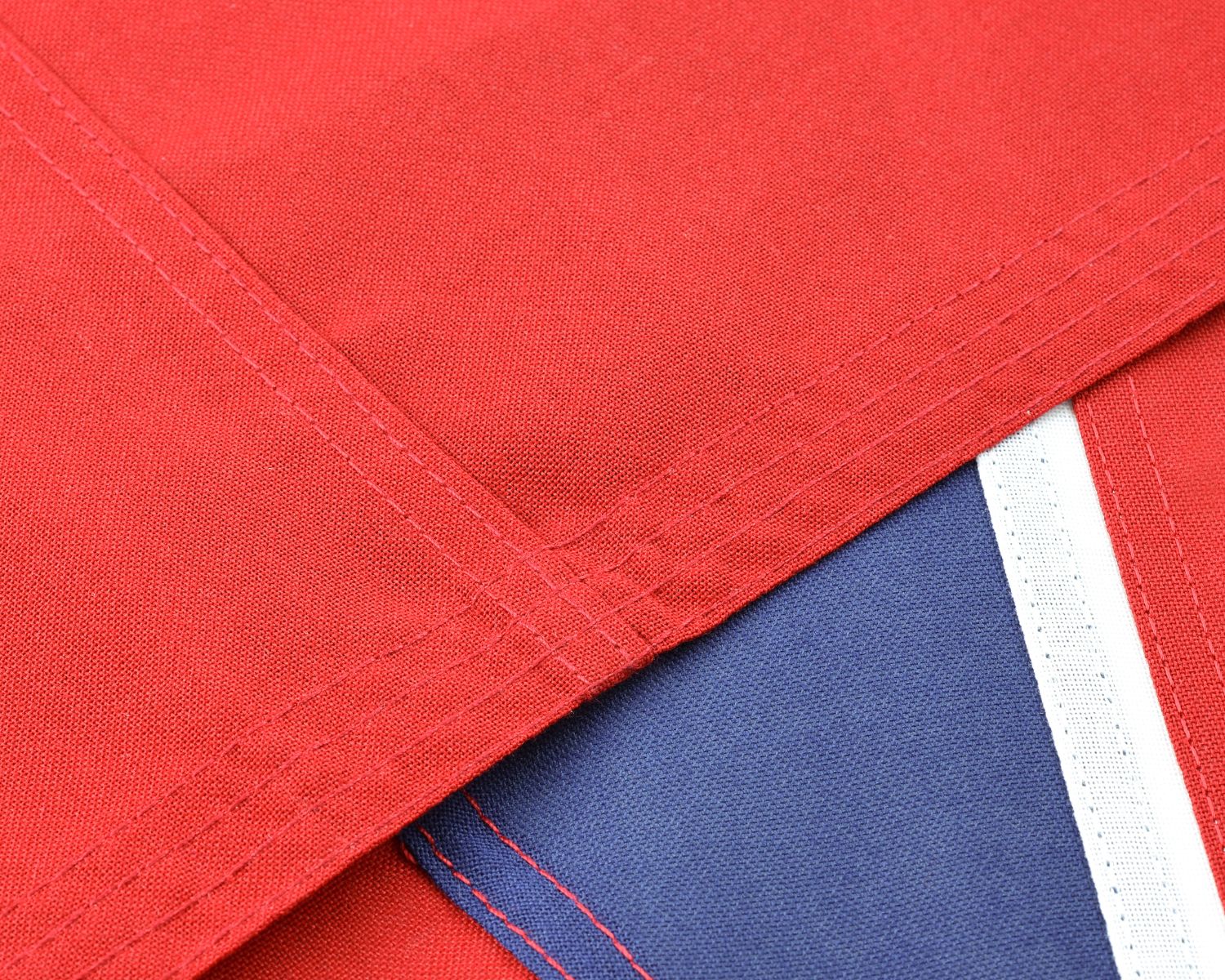 High-quality double-stitched seam detail joining sections of the historical Australian Red Ensign flag.