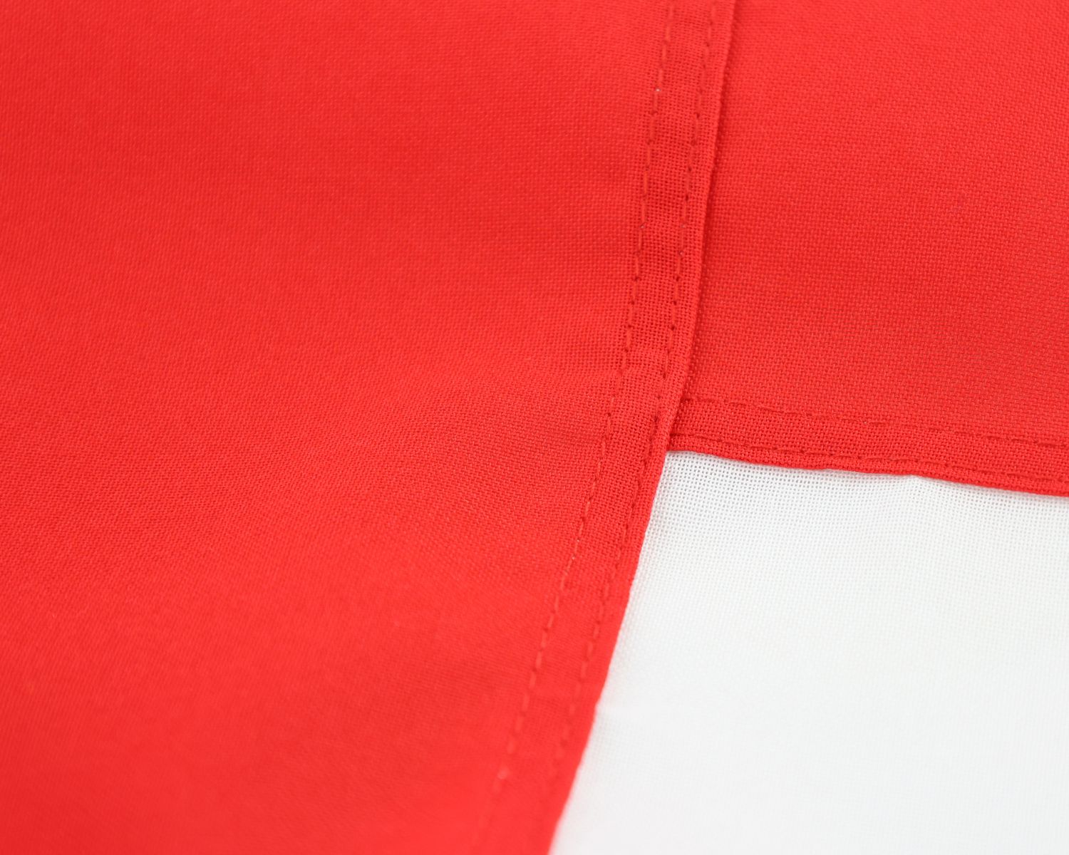 Close-up of the fully sewn England flag showing the red and white fabric panels.