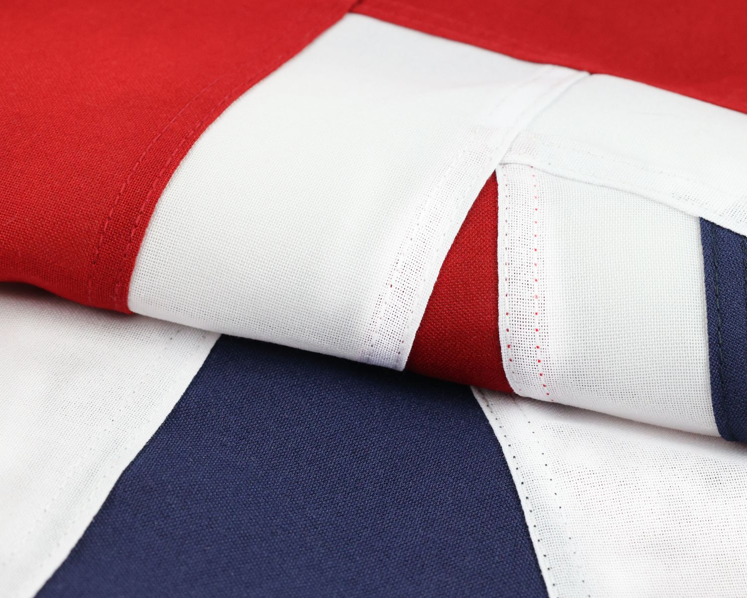 Detail photo of the fully sewn United Kingdom flag showing layered fabric and stitched seams.