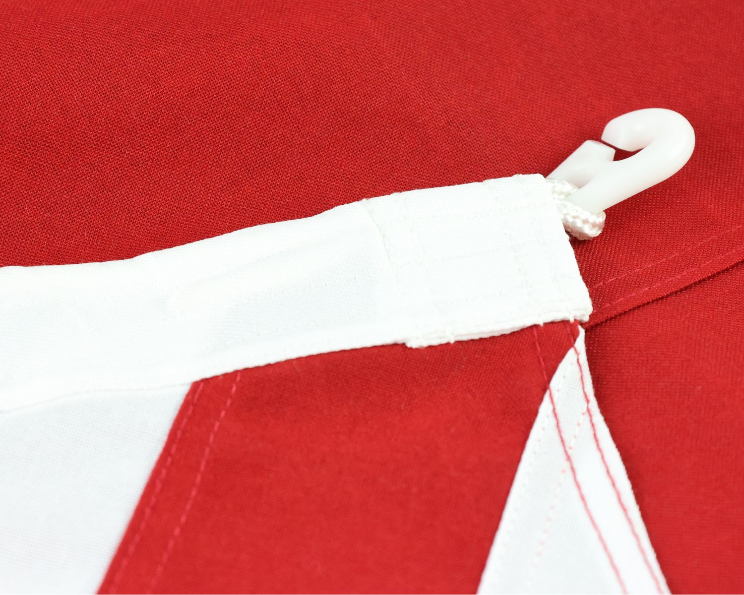 Close-up of the fully sewn United Kingdom flag showing the white header and plastic anti noise clip attachment.